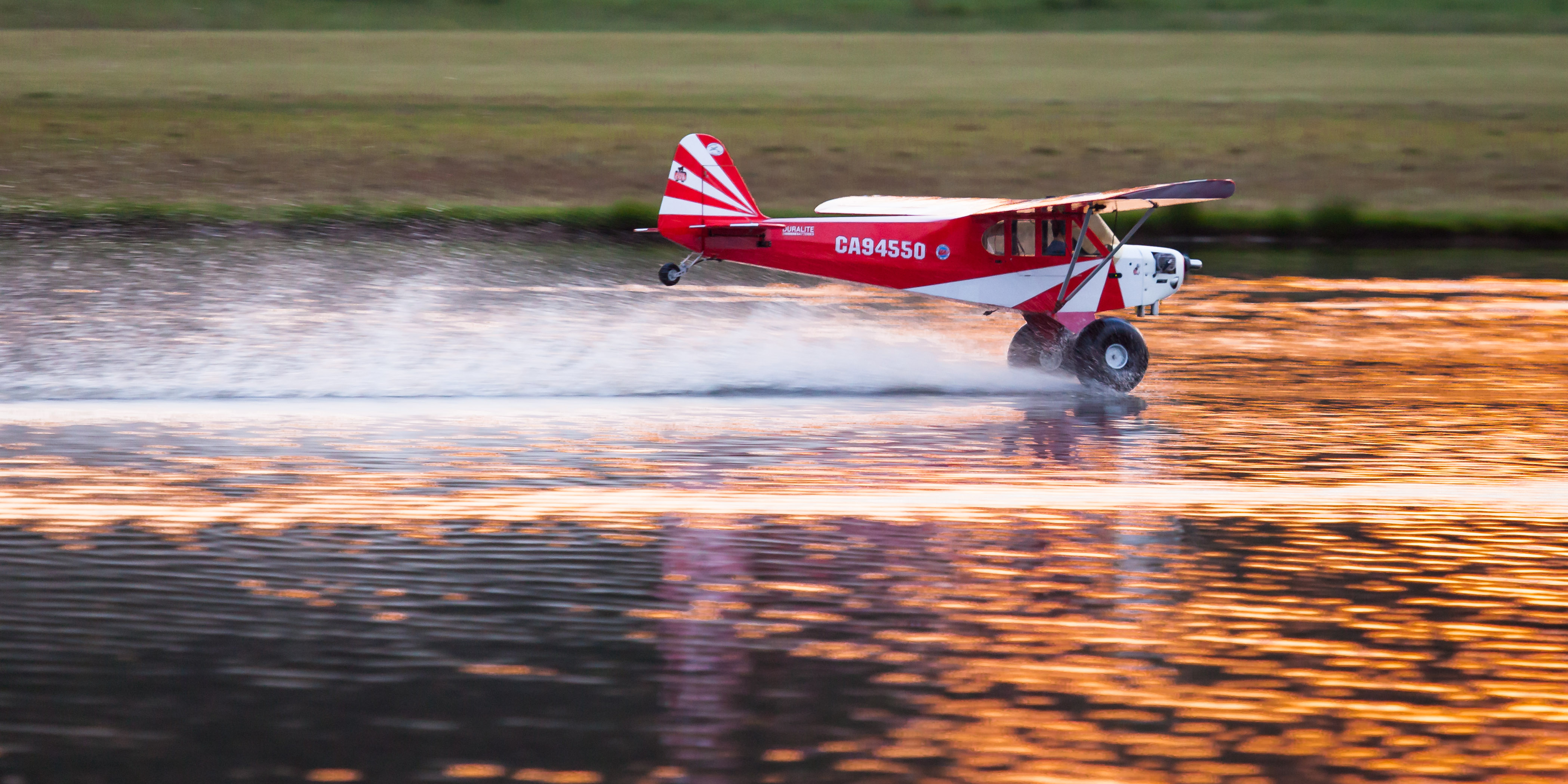 A World Models 1/3 scale Cub skims the water at Joe Nall 2015.