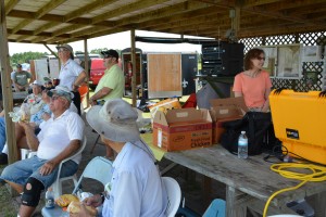 While participants huddle under the shade, Elaine prepares lunch for all.